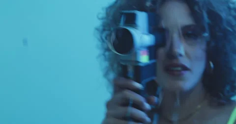 Girl holding a camera while covered in confetti. Stock Footage 204970177