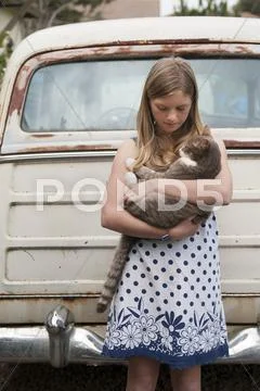 Girl holding cat near vintage car Stock Photos