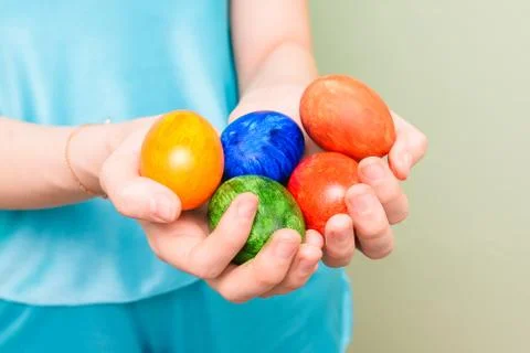 Girl holding colorful eggs. Bright Easter eggs in the hands of a woman. Close Stock Photos