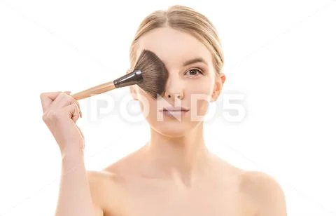 The girl holding a cosmetic brush on the white background Stock Photos