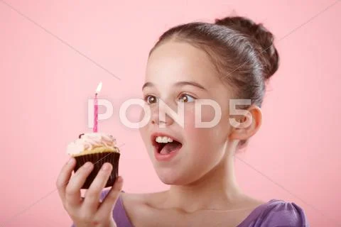 Girl Holding Cupcake With Candle