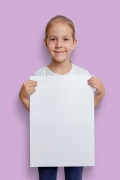 Girl holding empty blank vertical A3 poster for mockup, ad or text presentati Stock Photos