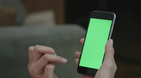 Girl Holding a green screen iphone Stock Footage 59771168