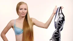 Girl holding many bras, Stock Video