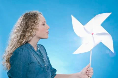 Girl holding paper windmill Stock Photos