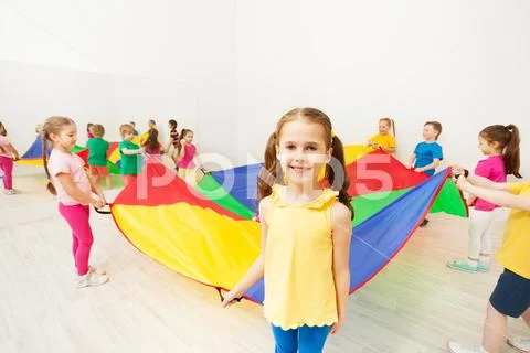 Girl holding parachute handle during funny game Stock Photos