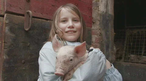 Girl holding piglet Stock Footage