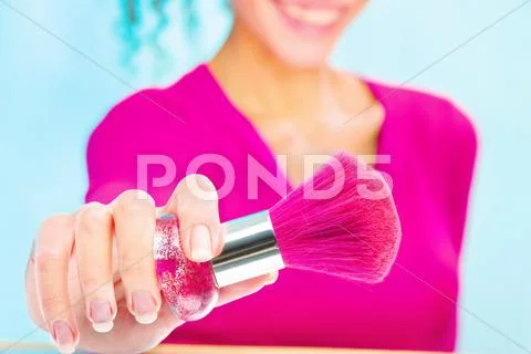 Girl holding powder brush, focus on brush Stock Photos