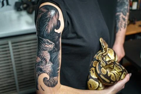 Girl holding python which is the sample for tattoo Stock-Fotos