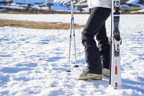 Girl holding skis not person. only legs. Stock Photos