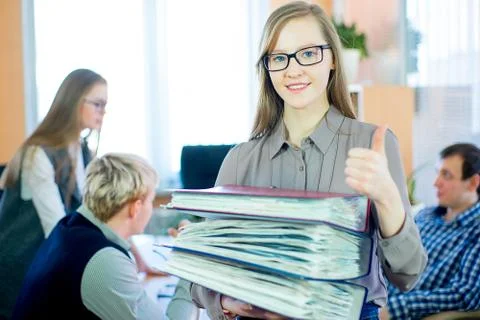 Girl holding a stack of documents Stock Photos
