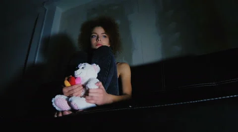 A girl holding a teddy bear and think of something sad Stock Footage 59237998
