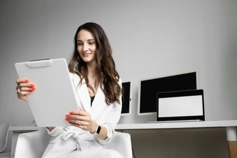 The girl is holding a white folder in the office Stock Photos