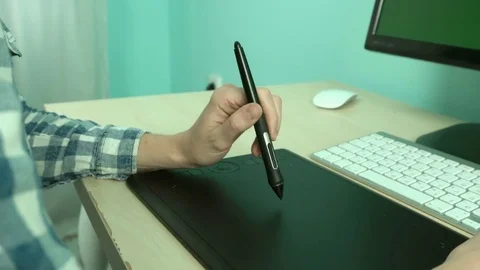 Girl illustrator working at the computer using a stylus and a graphic tablet Stock Footage 79671572
