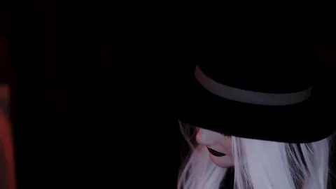 Girl in the image of a witch hat. Black background Stock Footage 69242707