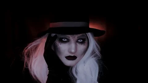 Girl in the image of a witch hat. Black background Video stock 69242805