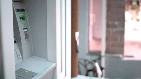 Girl inserts a card into an ATM machine Stock Footage 92644086