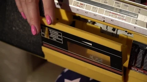 Girl inserts a tape in the recorder Stock Footage 80626697