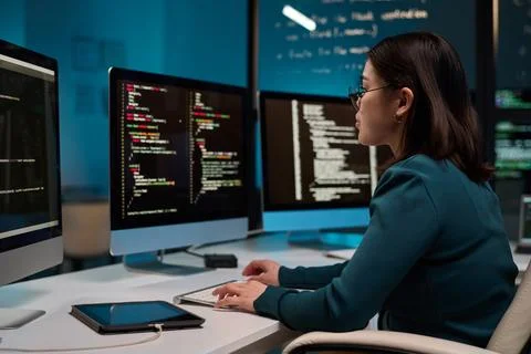 Girl as IT Developer Writing Code in Blue Light 스톡 사진