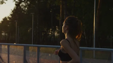 Girl jogging in the evening Stock Footage 100033418