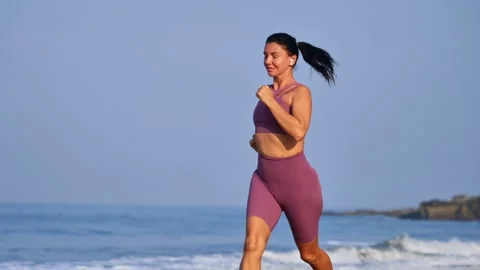 Girl jogging on the shore Stock Footage 265876965