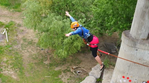 The girl jumped from the bridge with the help of an instructor Stock Footage 50751778