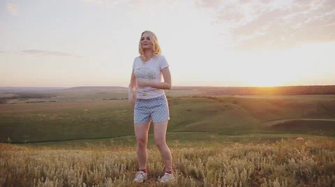 Girl jumping on the background of sunset. Stock Footage 64321026