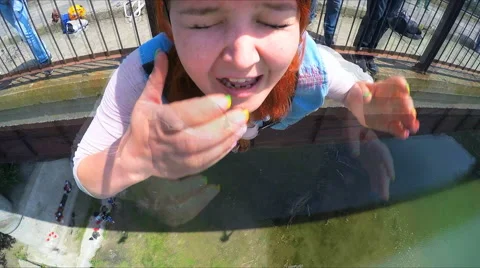 Girl jumping from the bridge facing forward missing his nose Stock Footage 49912622