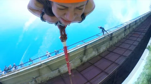 Girl jumping from the bridge facing forward clutches his chest Stock Footage 49914878