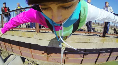 Girl jumping from the bridge facing forward your arms Stock Footage 52428962