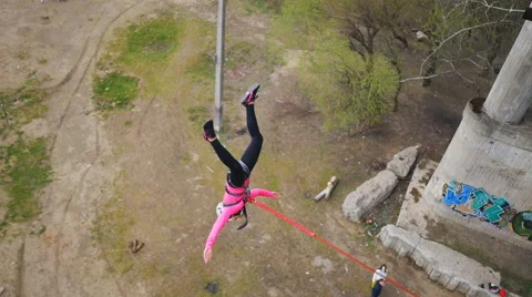 Girl jumping from the bridge facing forward his arms Stock Footage 68347863