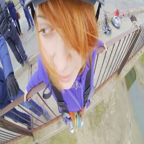 Girl jumping from the bridge forward looking at the instructor Stock Footage 69538425