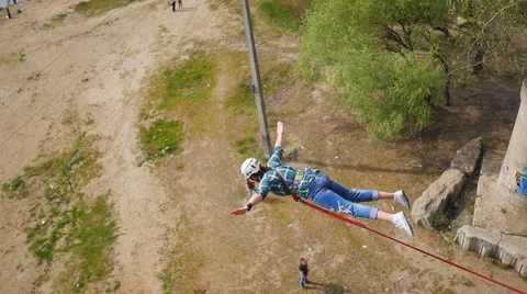 Girl jumping from the bridge with the help of an instructor Stock Footage 68350094