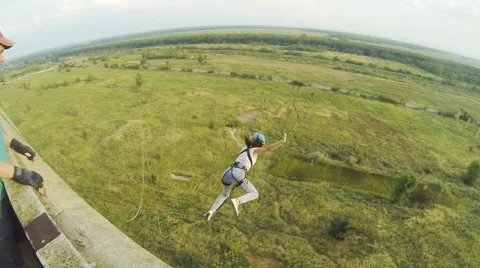 Girl jumping with the help of an instructor Stock Footage 68071447