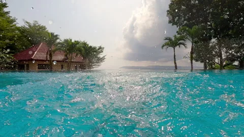 Girl Jumping In The Infinity Pool Stock Footage 244744691