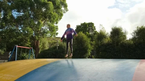 Girl jumping on jumping pillow Stock Footage 242560452