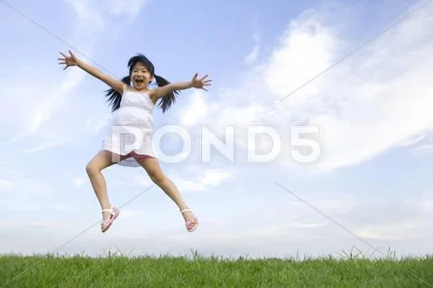Girl jumping in mid-air Stock Photos