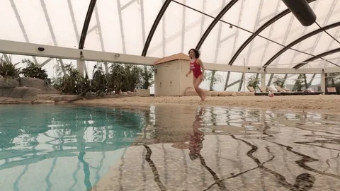 Girl jumping into the pool Stock Footage 89612899