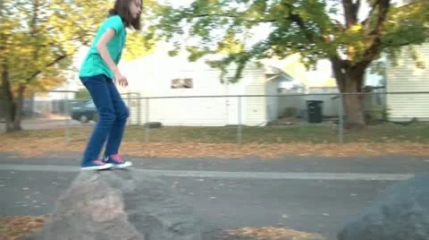 Girl Jumping onto Rocks in Fall Stock Footage 12582715