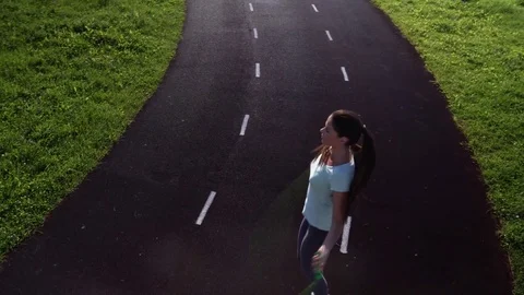 A girl is jumping rope on a treadmill of the stadium Stock Footage