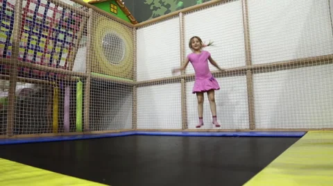 A girl jumping on a trampoline Stock Footage 64544216