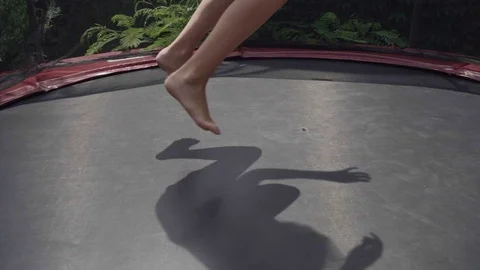Girl jumping on trampoline in slow mot... | Stock Video Pond5