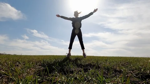 The girl jumps and makes handclaps over her head. Stock Footage 127640468