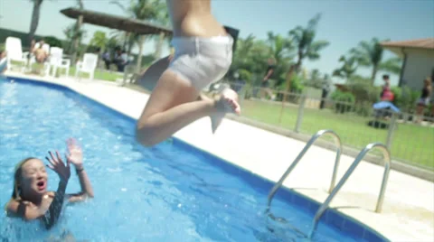 Girl jumps in to the pool Video stock 34285612