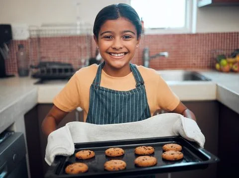 Girl kid, cookies and baking with portrait and bakery skill, learning and Stock Photos
