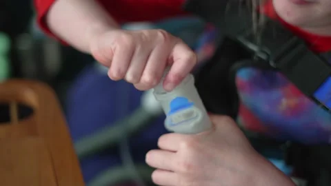 Girl kid with Cystic Fibrosis doing daily shakey vest and nebulizer respiratory Stock-Footage