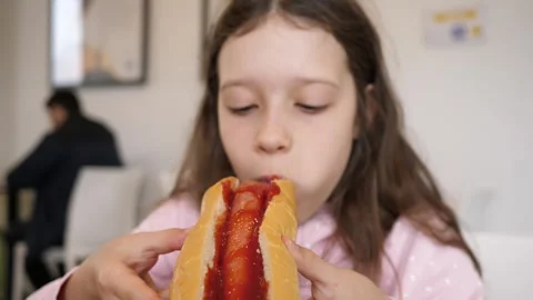 Girl kid portrait eating biting a huge h... | Stock Video | Pond5