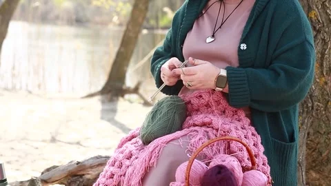 A girl knits clothes from wool Stock Footage 309233341