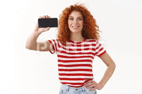 Girl knows last digital trends. Attractive charismatic ginger girl curly Stock Photos
