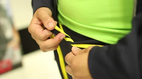 Girl lacing pants while trying on clothes 스톡 동영상 47176377